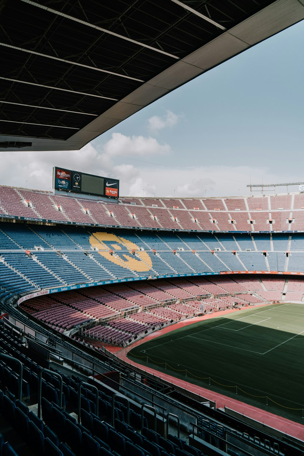 blue and red stadium under blue sky during daytime