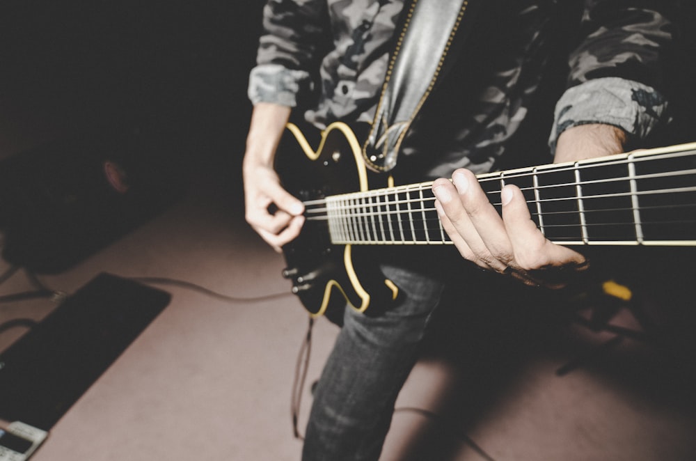 person playing electric guitar on the street