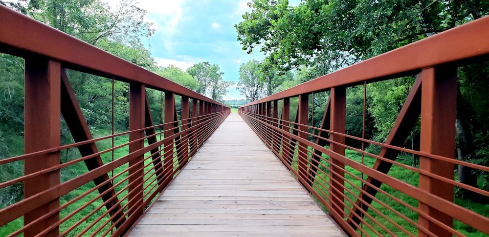 brown wooden bridge under blue sky during daytime