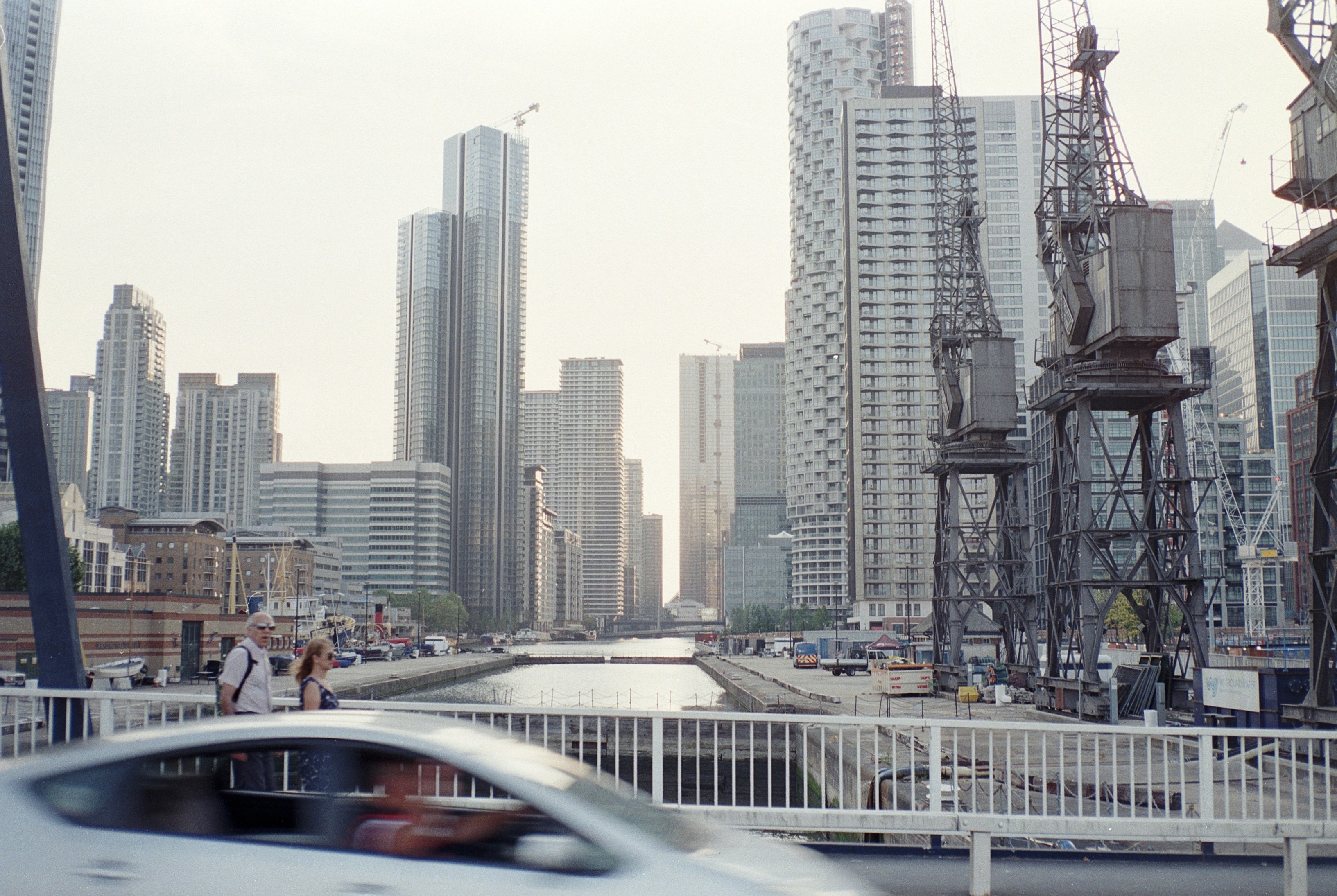 cars on road near city buildings during daytime