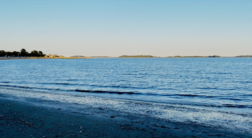 body of water under blue sky during daytime