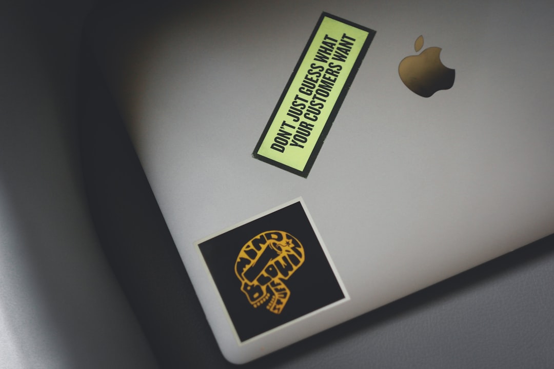 macbook pro with yellow and black sticker