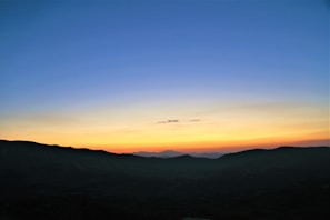 A beautiful landscape showcasing mountains and a sunset.
