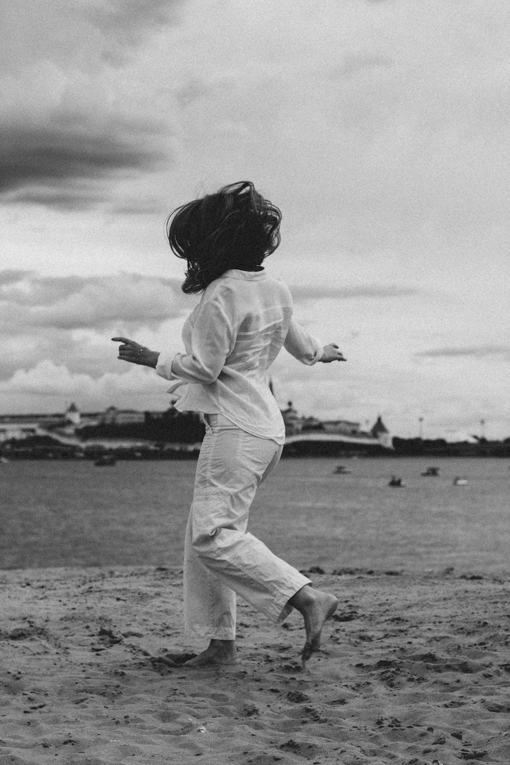 grayscale photo of girl in white long sleeve shirt and pants