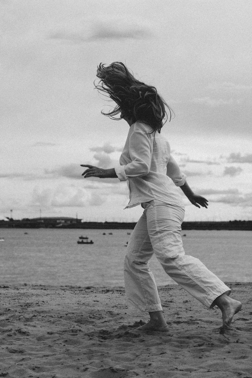 grayscale photo of woman in white long sleeve shirt and pants