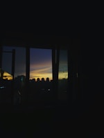 View of the São Paulo city skyline from the office window during sunset.