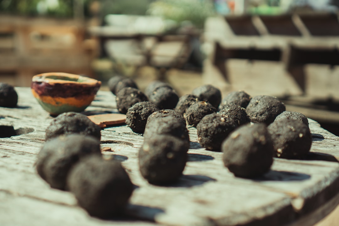 black round fruits on brown wooden table