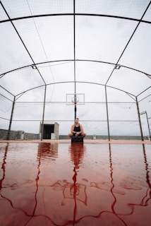 Athlete wearing a waist support while playing an intense game of basketball outdoors.