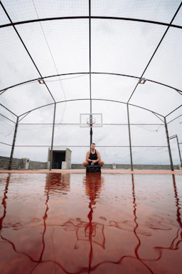 Athlete wearing sturdy knee pads while preparing for a game on an outdoor court.
