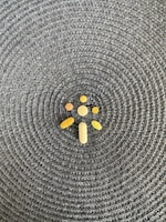 Close-up of natural herbal pills arranged on a wooden surface.