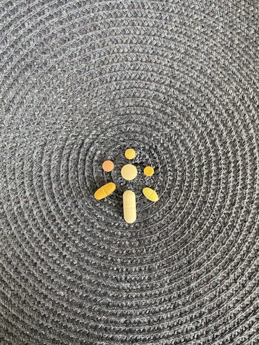 A collection of vibrant herbal tablets arranged aesthetically on a wooden surface.
