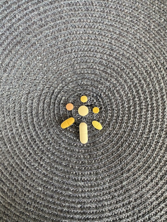 A vibrant display of assorted prescription medicines neatly arranged on a wooden table.