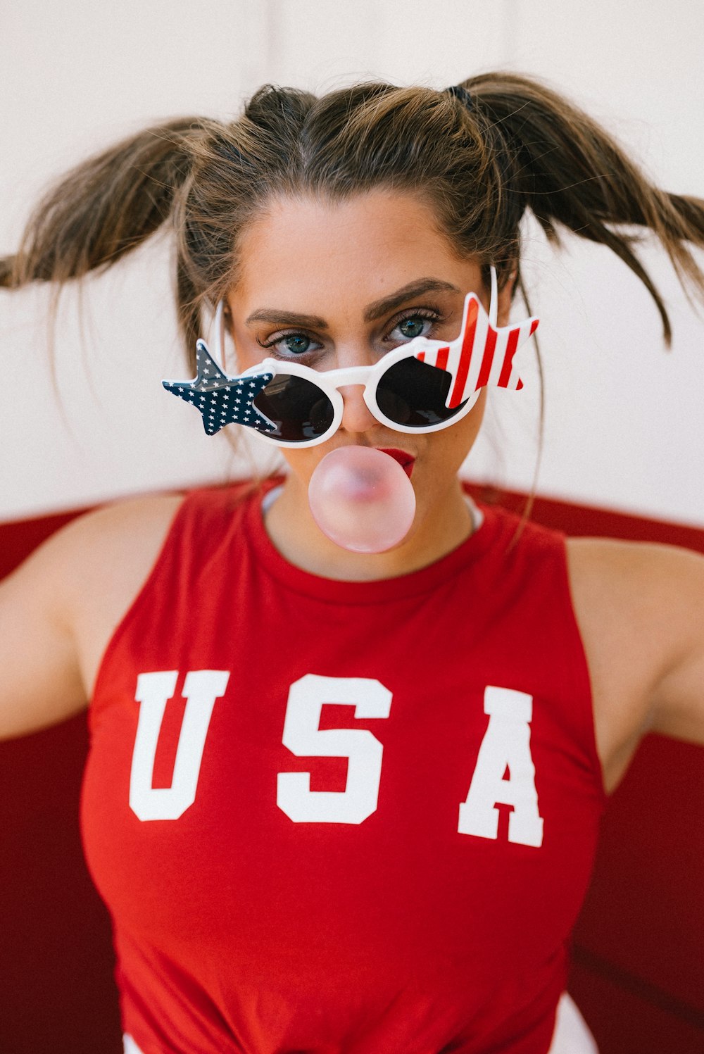 woman in red tank top wearing sunglasses