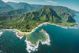 aerial view of green and brown mountains and lake