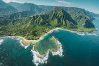 aerial view of green and brown mountains and lake
