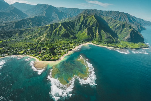 aerial view of green and brown mountains and lake