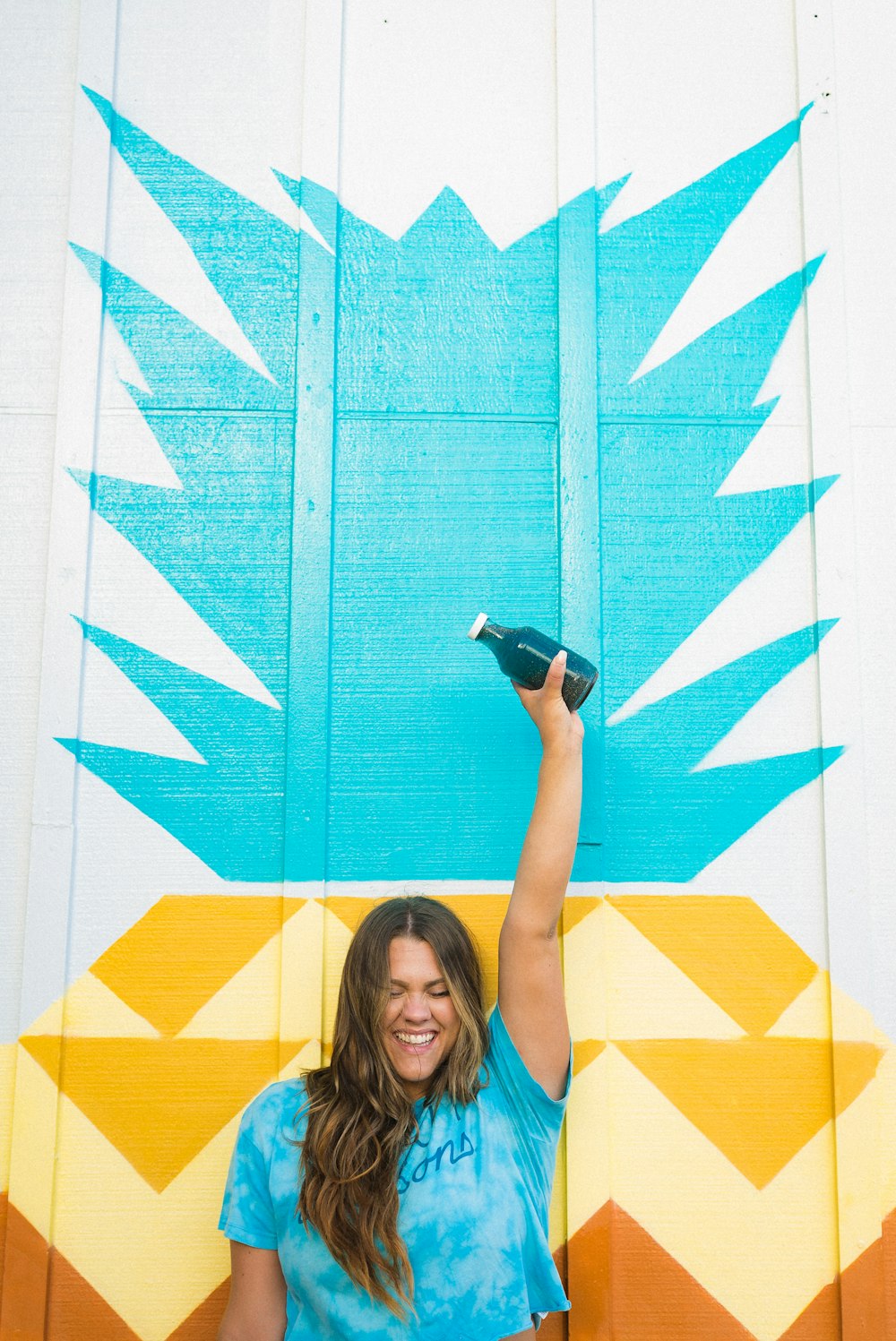 woman in blue t-shirt holding black dslr camera