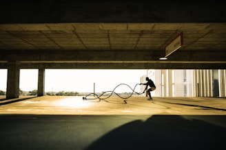 man in black shirt and pants riding bicycle on gray concrete road during daytime