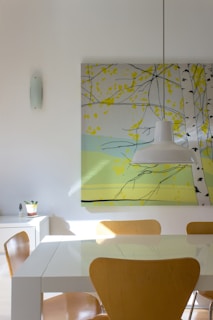 A modern dining area with a minimalist table and artistic lighting