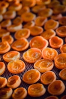 Close-up of golden apricots drying under the Afghan sun.