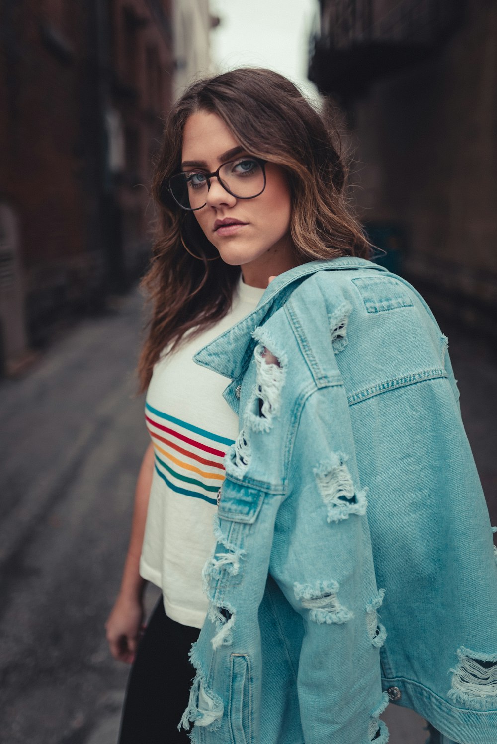 woman in blue denim jacket and white red and blue striped shirt