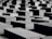 Numerous large concrete slabs are arranged in a grid-like pattern. The structures vary slightly in height, creating a visually striking geometric landscape. The shadows cast by the blocks add depth to the scene.