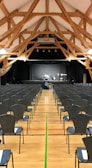 Spacious hall with stage and seating arranged for a cultural event.