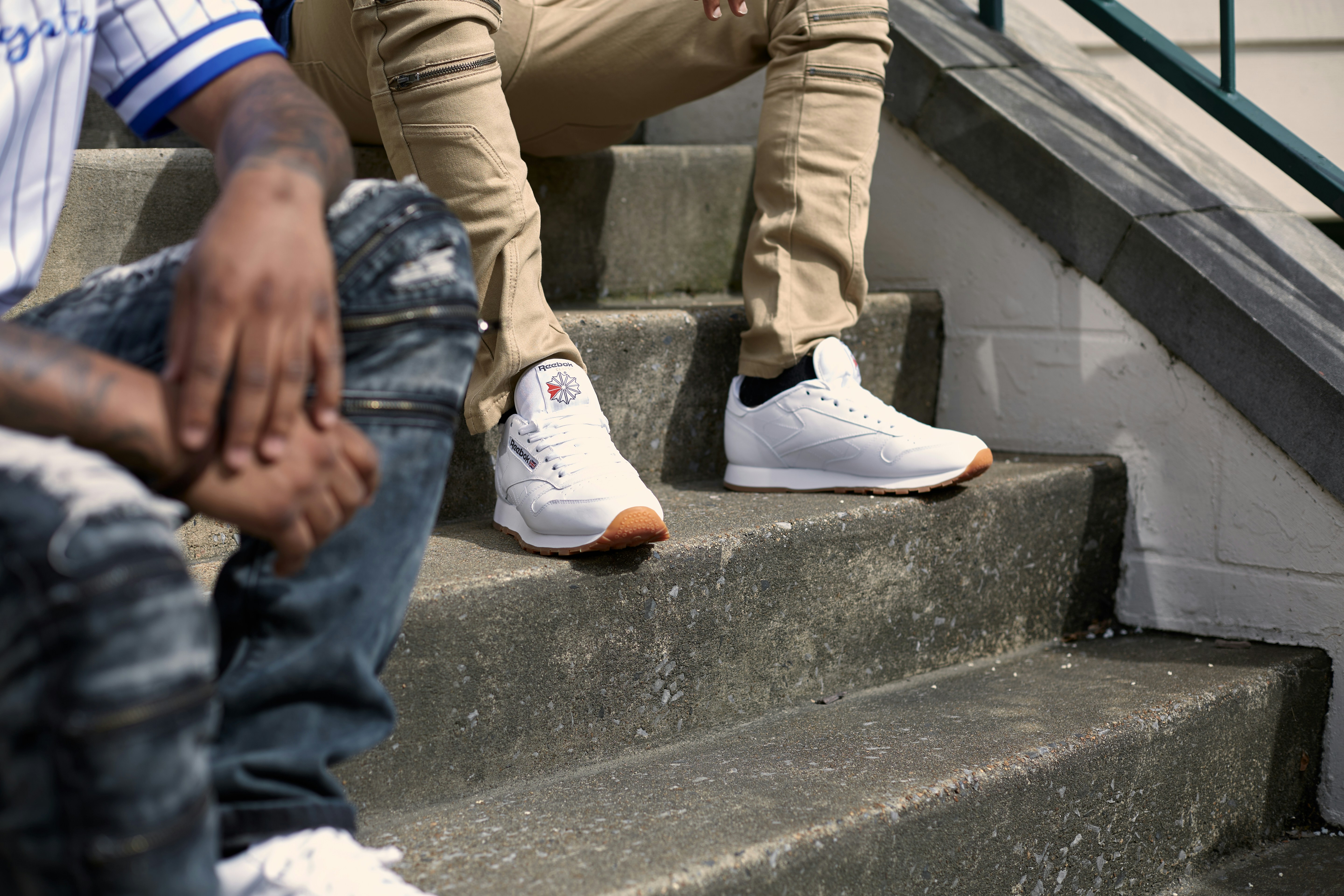 person in brown pants and white sneakers