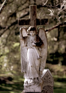 gray concrete angel statue during daytime