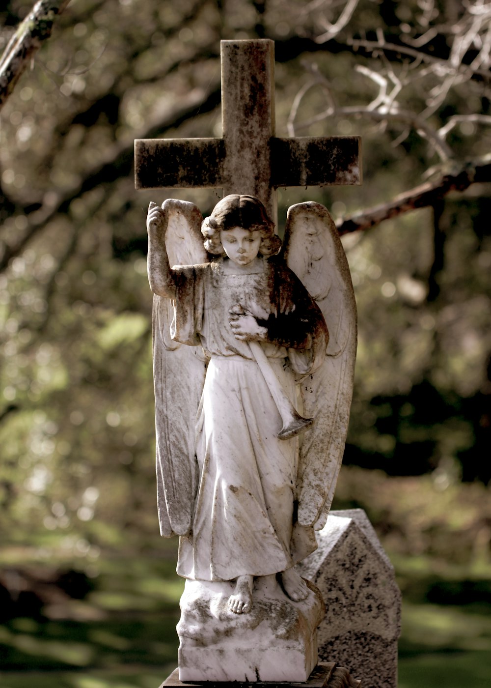 gray concrete angel statue during daytime