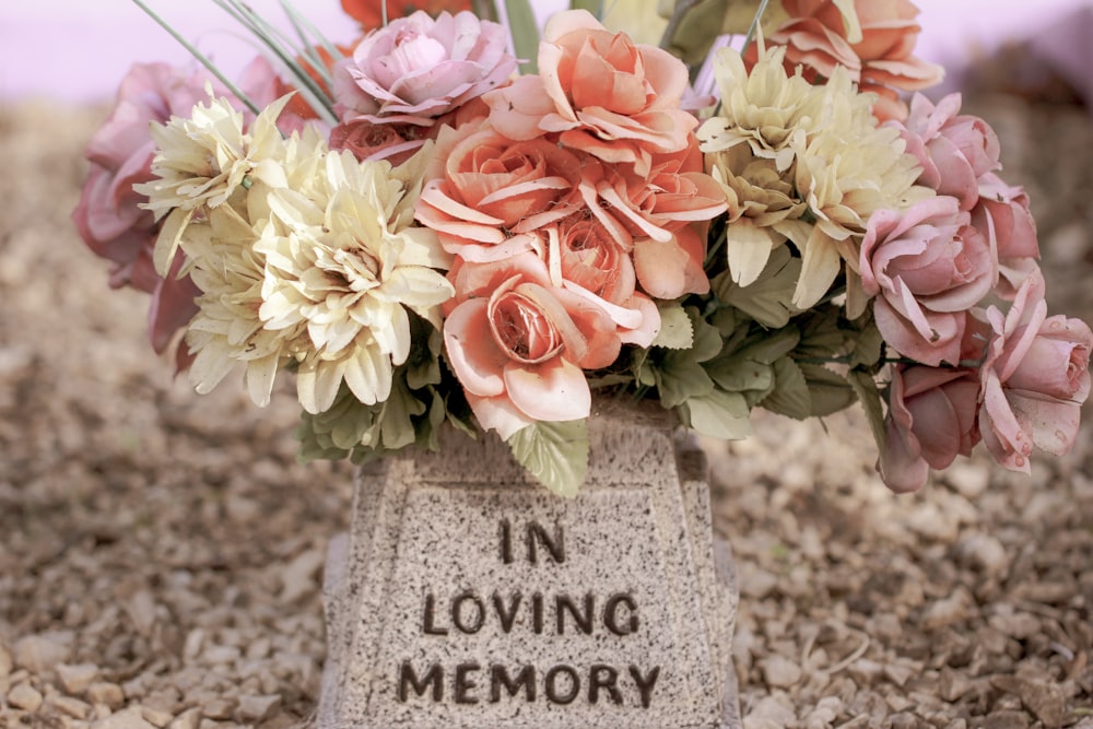 pink and white flowers on gray concrete tomb