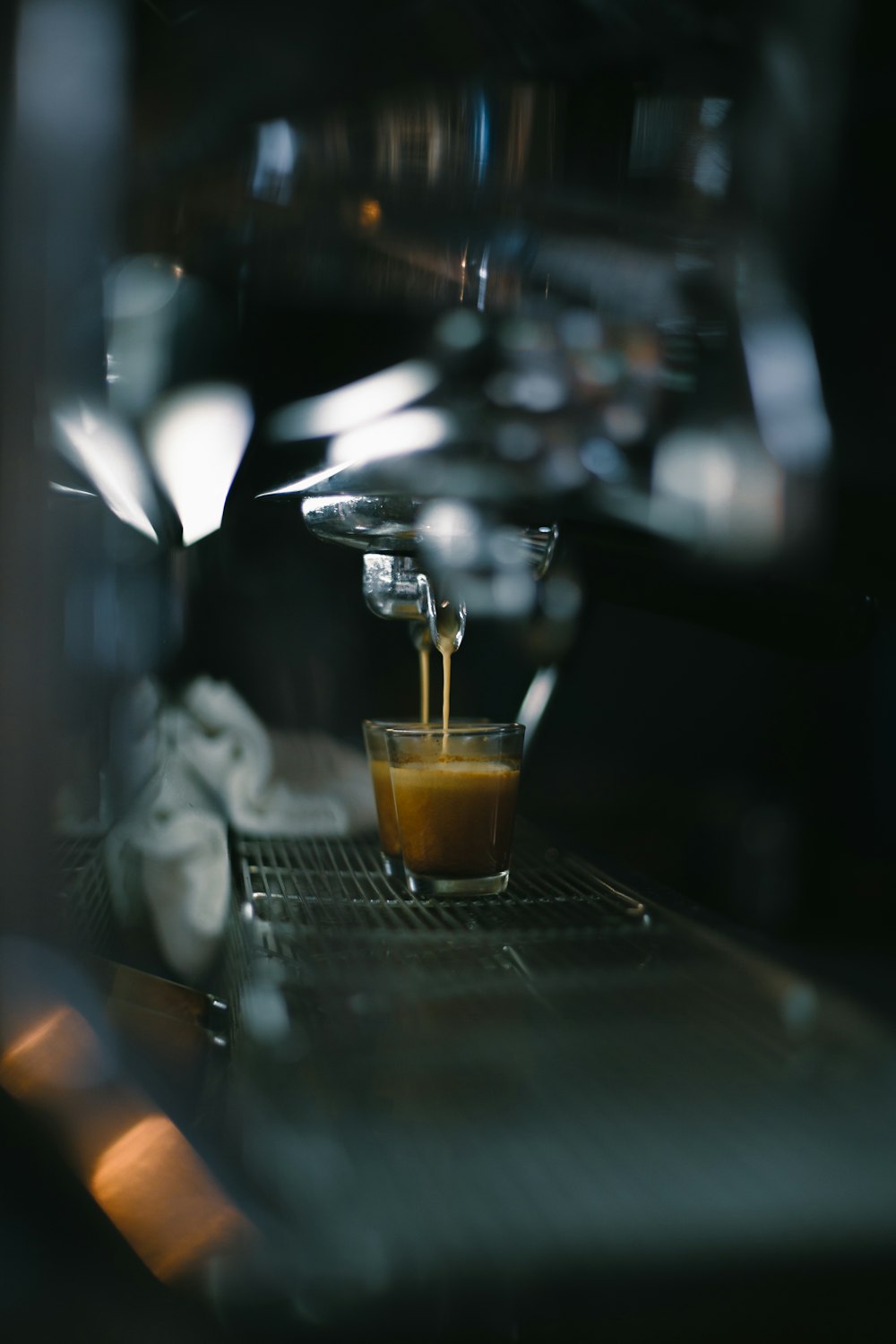 a glass filled with liquid sitting on top of a counter