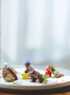 A close-up of a beautifully plated high-end cuisine dish, showcasing vibrant colors and artistic presentation.