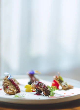 Close-up of an elegant plated dish featuring fresh ingredients and artistic presentation.