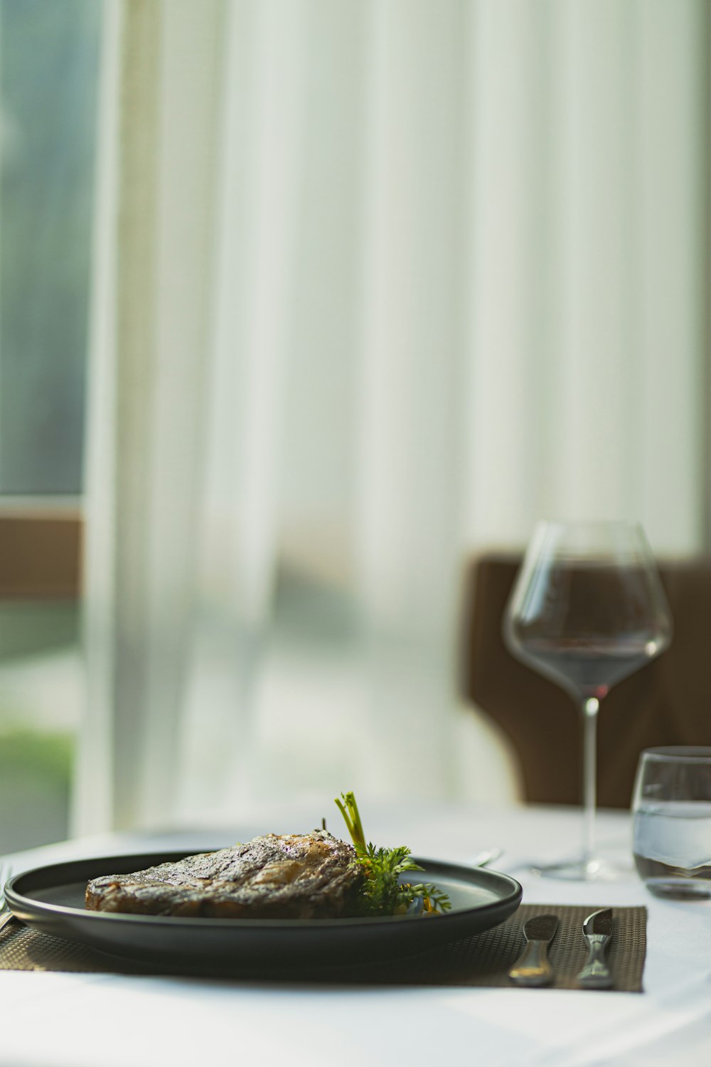 clear wine glass on white ceramic plate