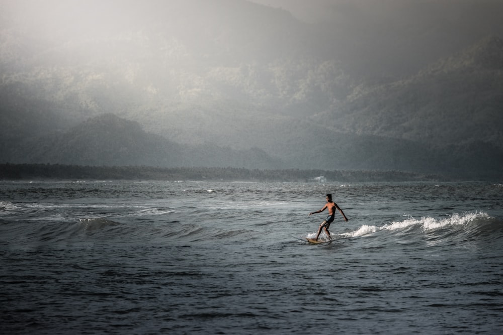 person surfing on sea during daytime