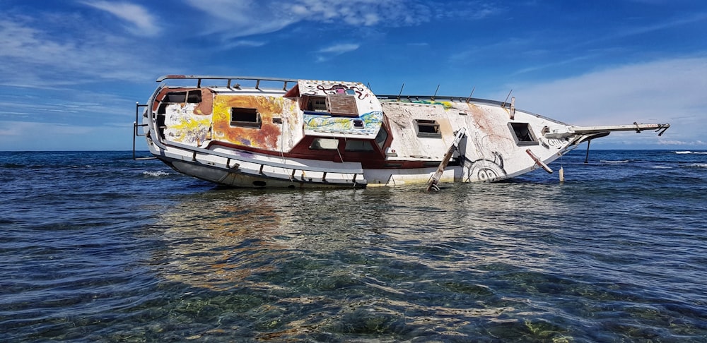 white and brown boat on water during daytime