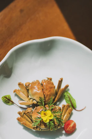 cooked crab on white ceramic plate