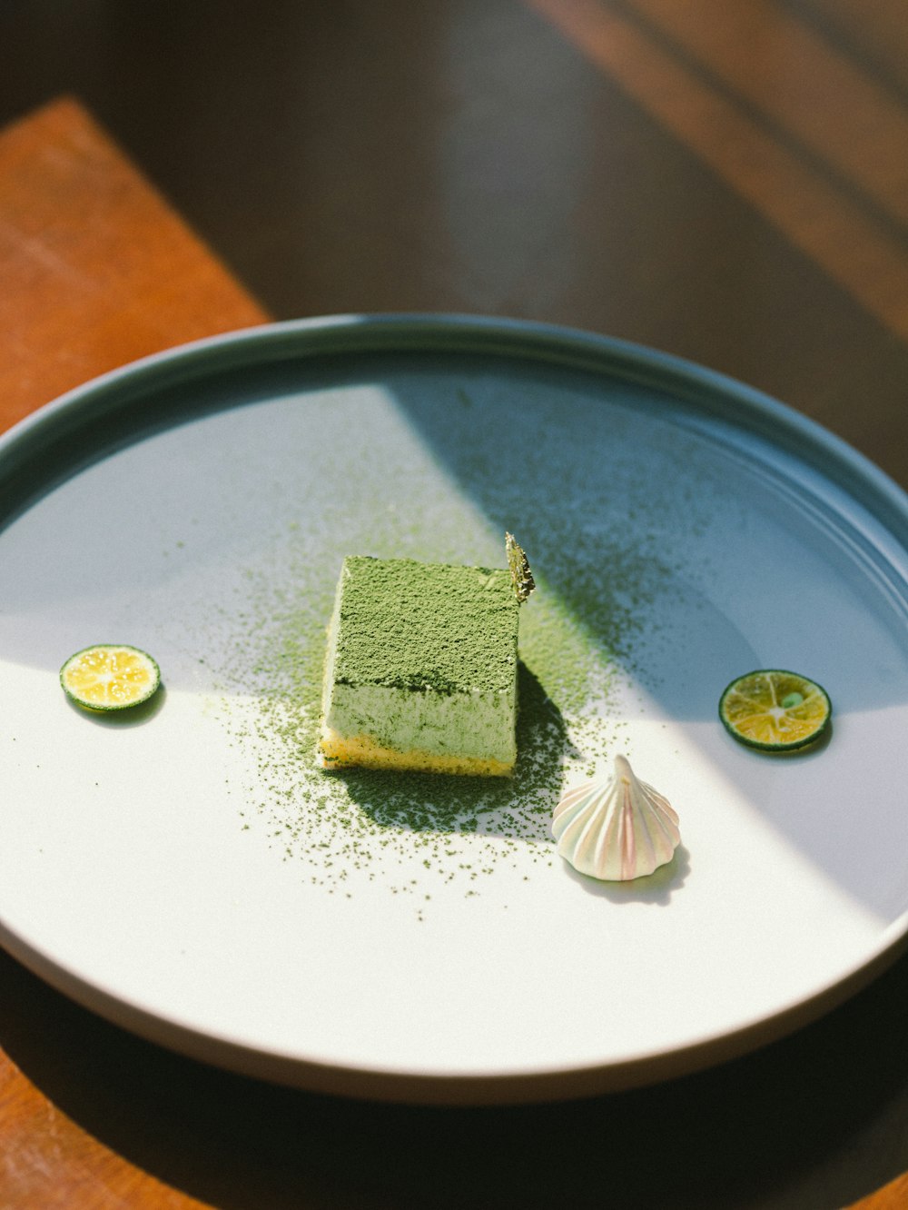 green and white cake on blue and white ceramic plate