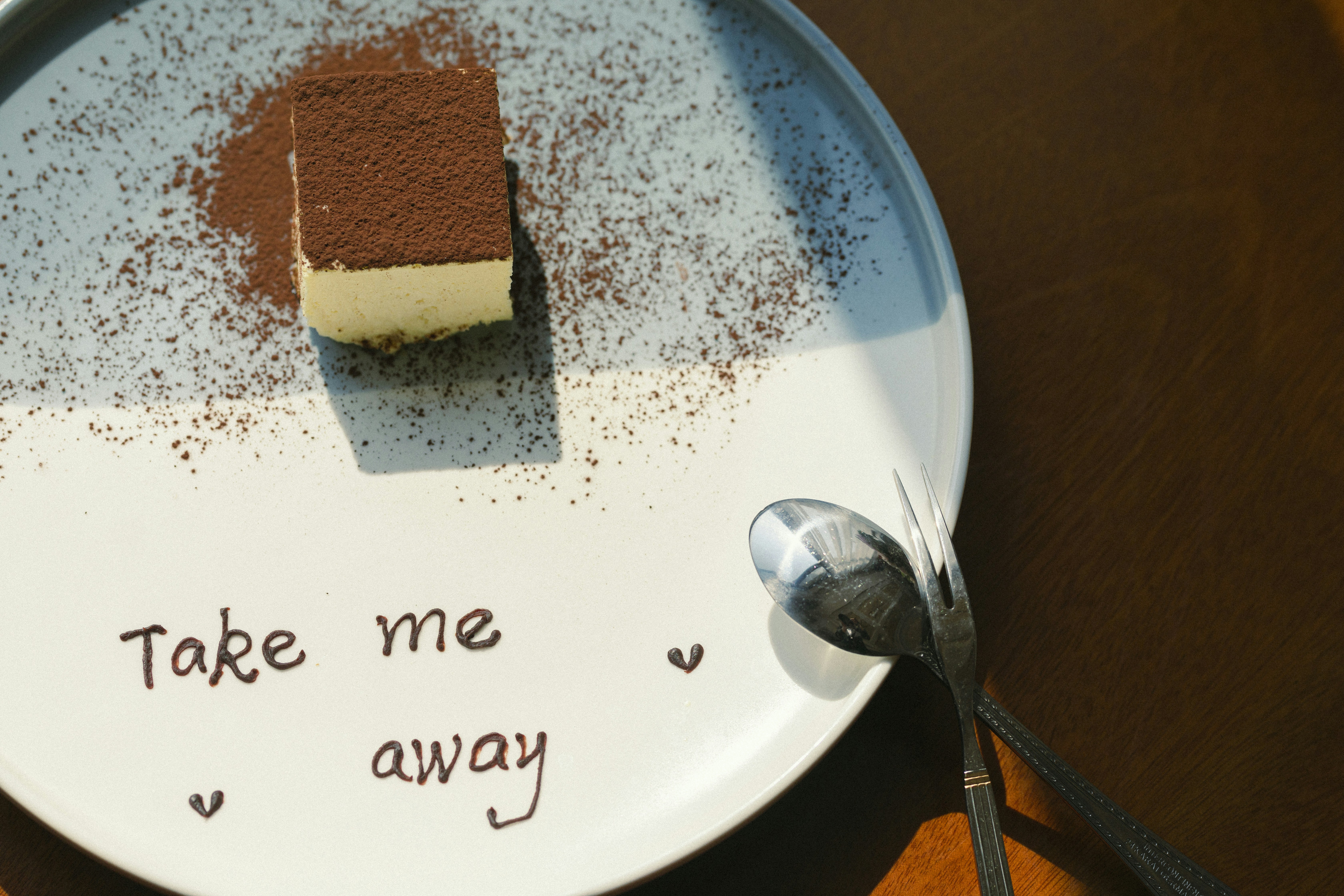 Tiramisu slice on a plate written Take me away