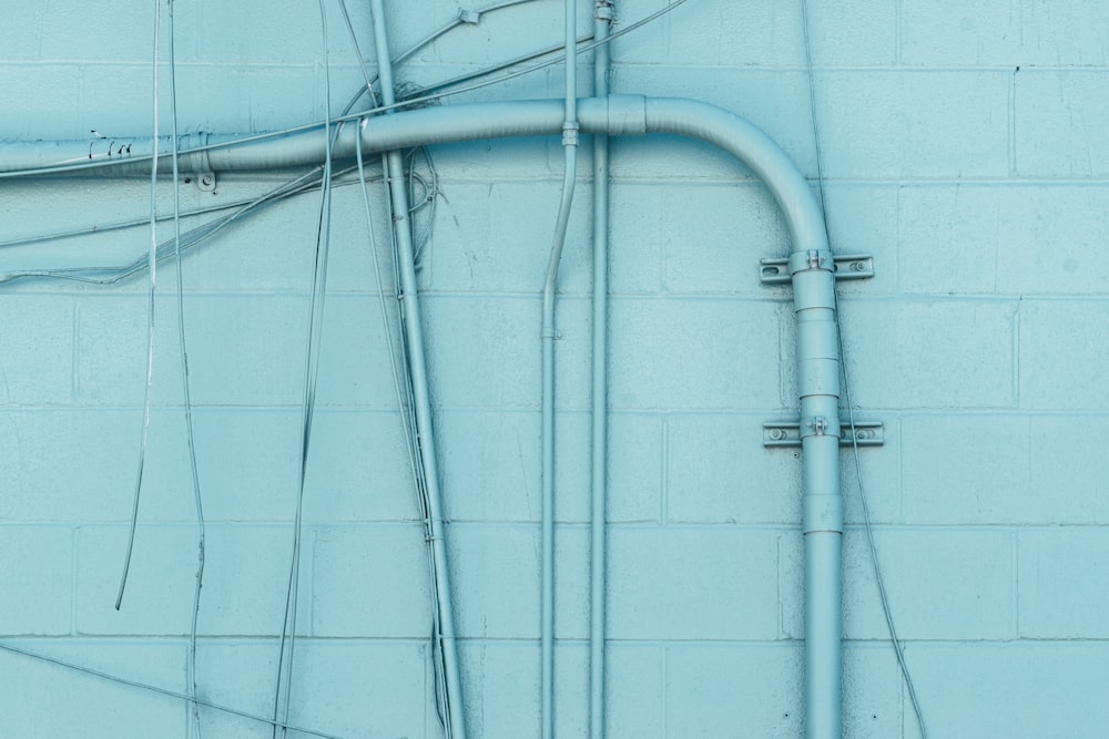 white coated wire on blue wall