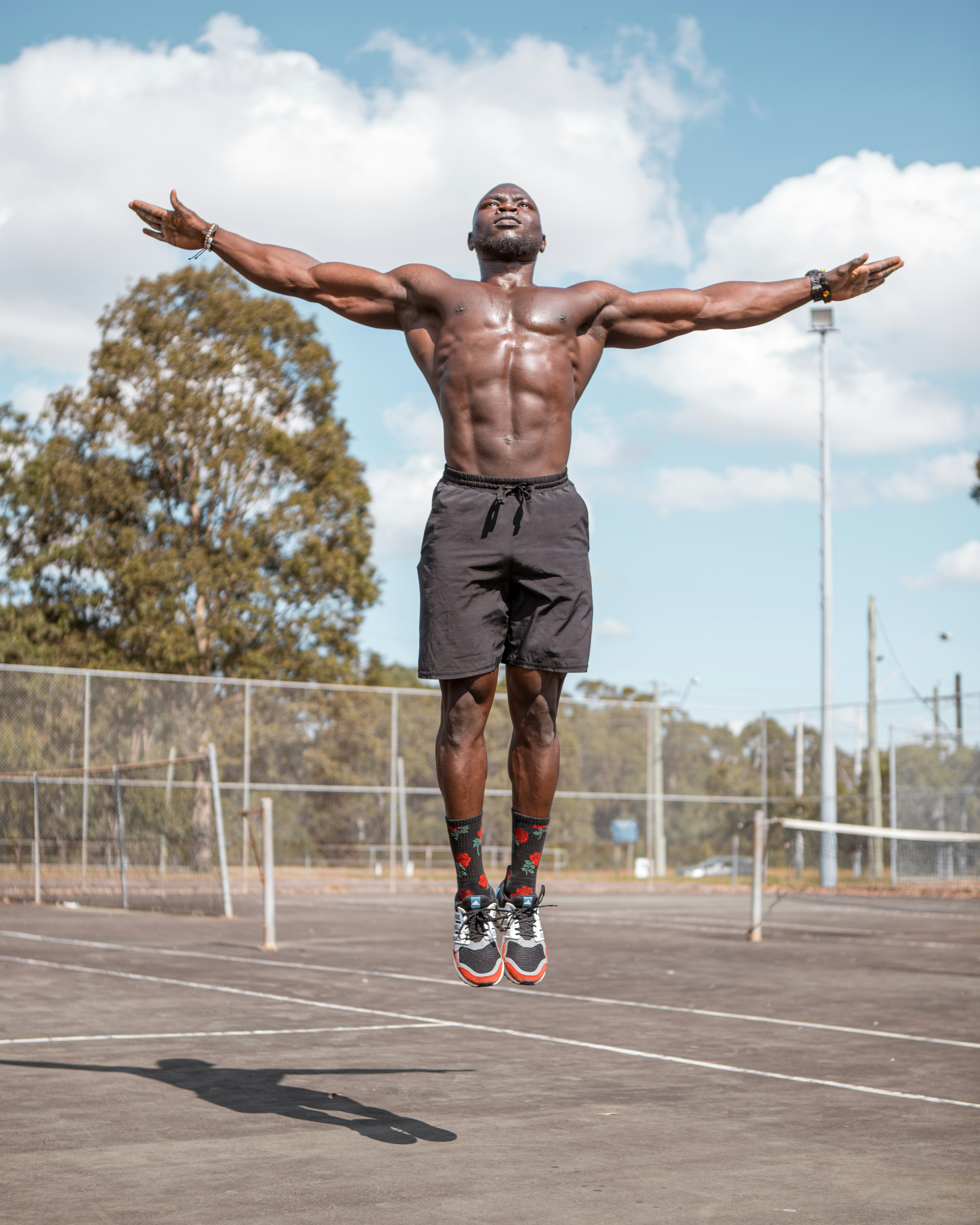 man in black shorts standing on basketball court