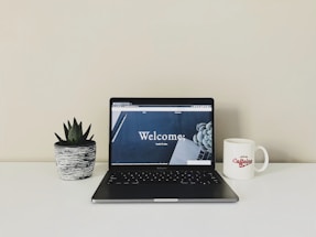 A welcoming office desk with a laptop and contact materials.