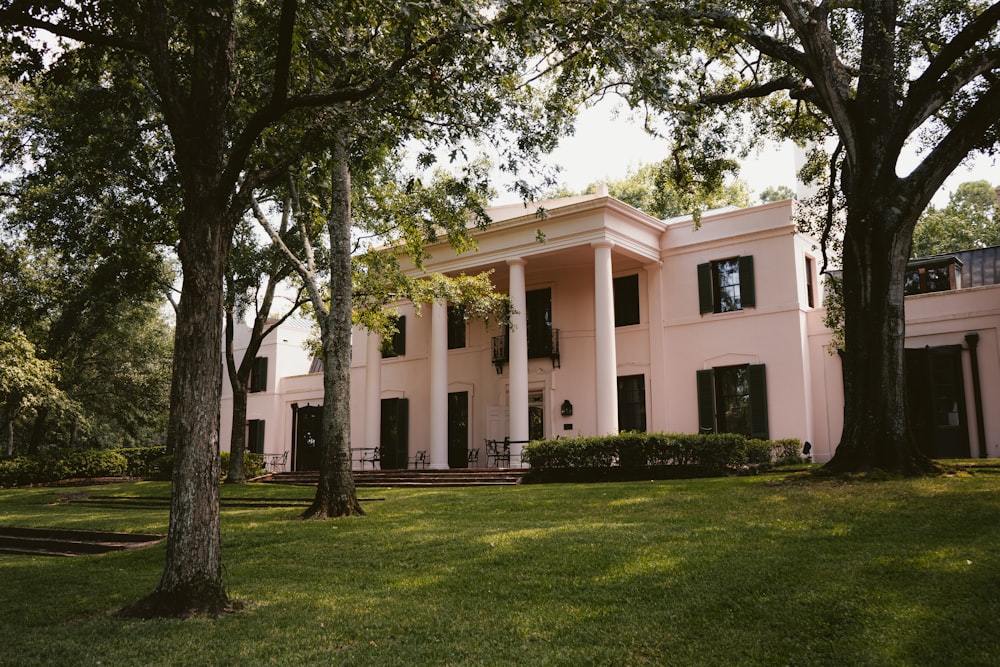 white concrete building near green trees during daytime