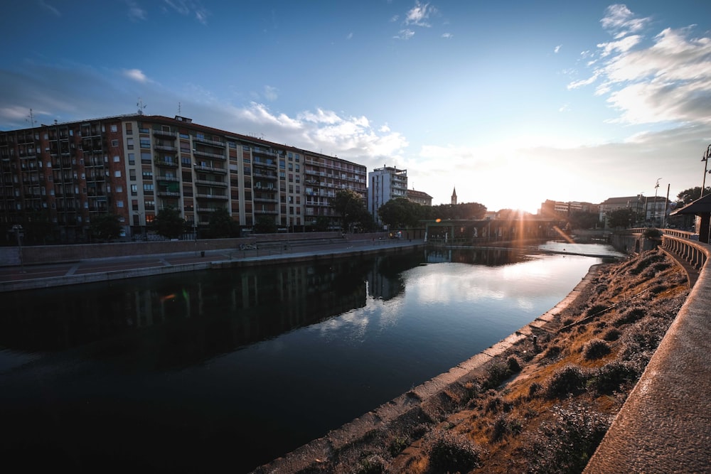 body of water between buildings under blue sky during daytime