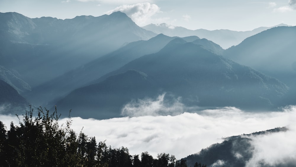 a view of a mountain range covered in clouds