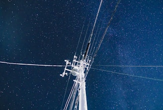 white electric post under blue sky during night time