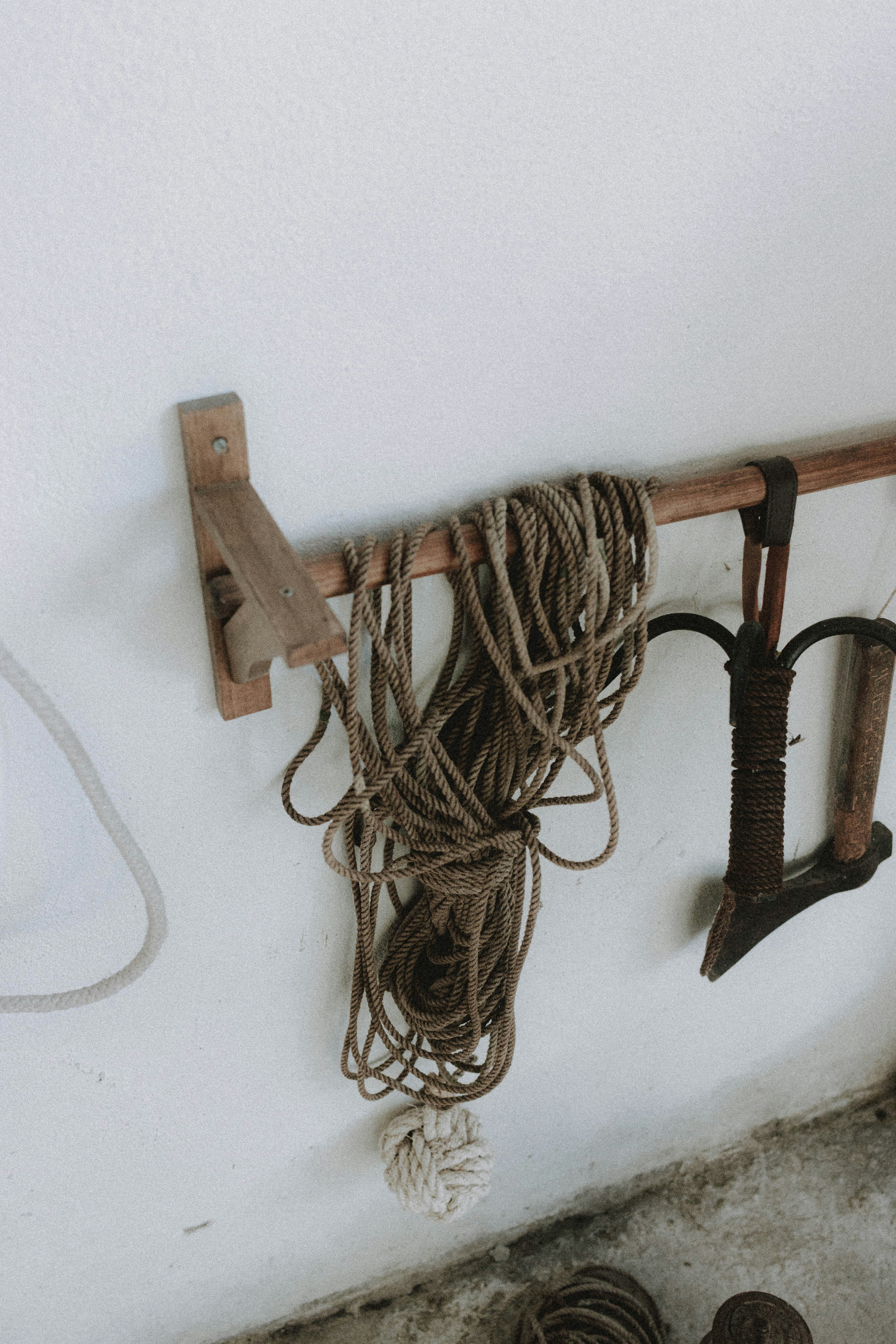 brown wooden clothes hanger on white wall