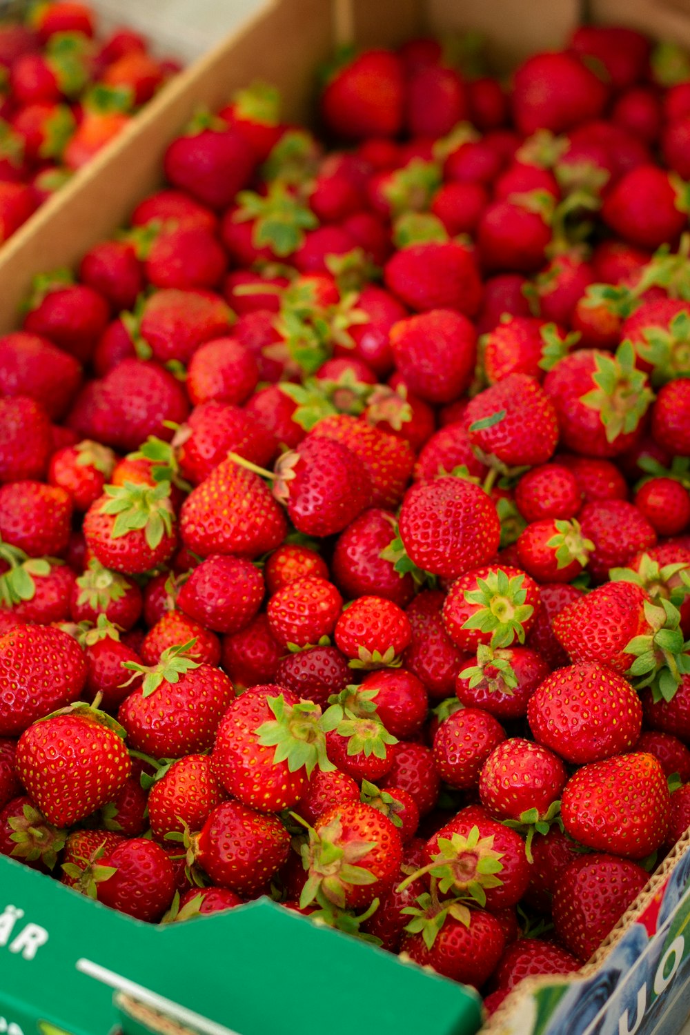 red strawberries in brown plastic container