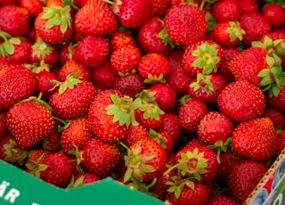 red strawberries in brown plastic container